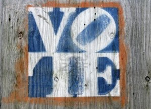 faded-colors-vote-sign-on-a-weathered-gray-plywood
